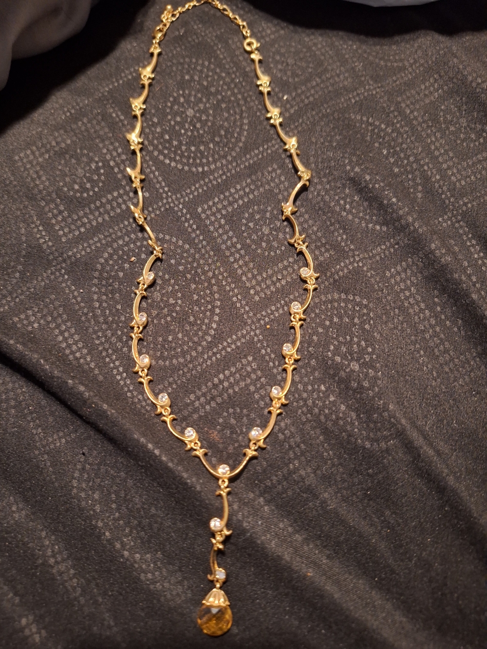 vintage gold-tone vine necklace featuring clear crystal accents and an amber-